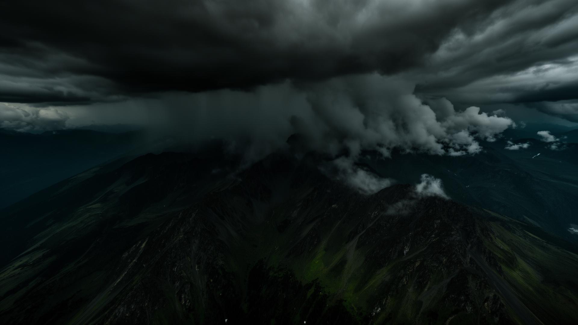 Winter storm clouds building over mountain terrain, the conditions targeted by cloud seeding